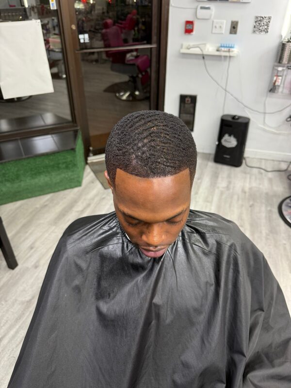 Overhead view of a 360-degree waves haircut with a sharp, crisp hairline