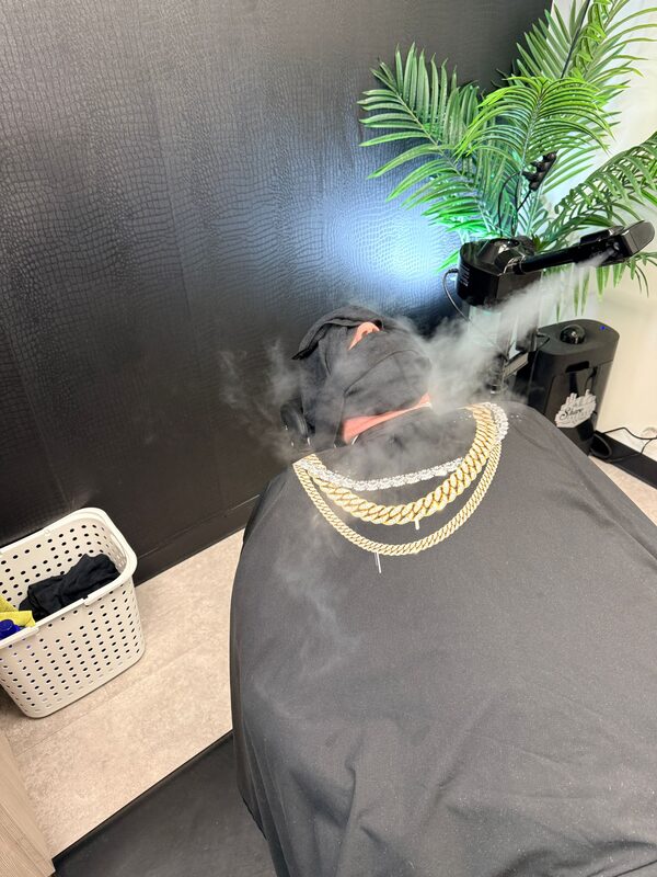 Client receiving a hot steam towel treatment at the barbershop
