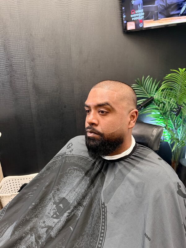 Side profile of a close buzz cut with a full beard