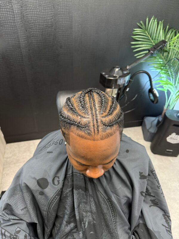 Overhead view of cornrow braids styled straight back into a woven bun