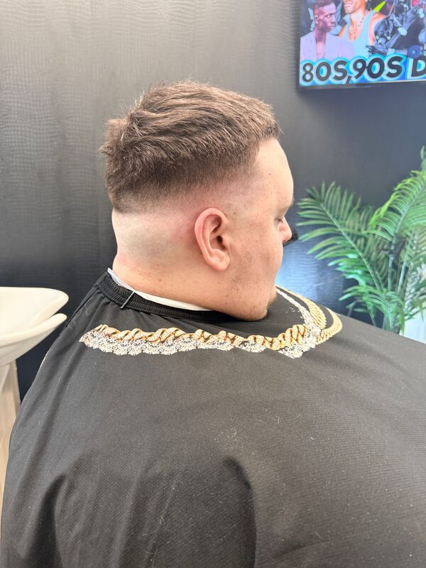 Back of the head showing a textured comb-over top with a sharp fade