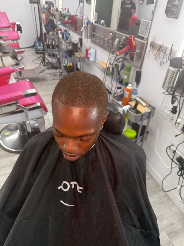 Overhead view of a short, even buzz cut with a clean fade