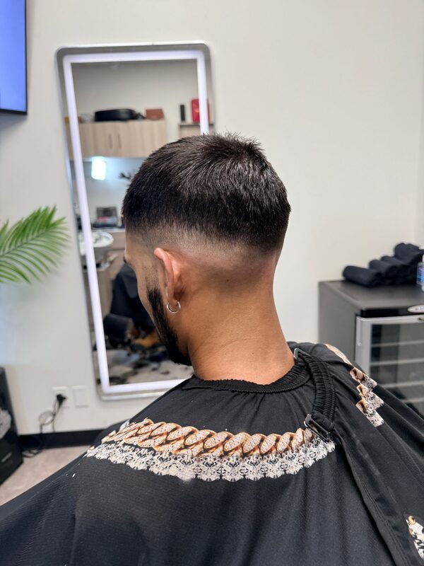 Back of the head showing a short buzzed crop with a clean skin fade