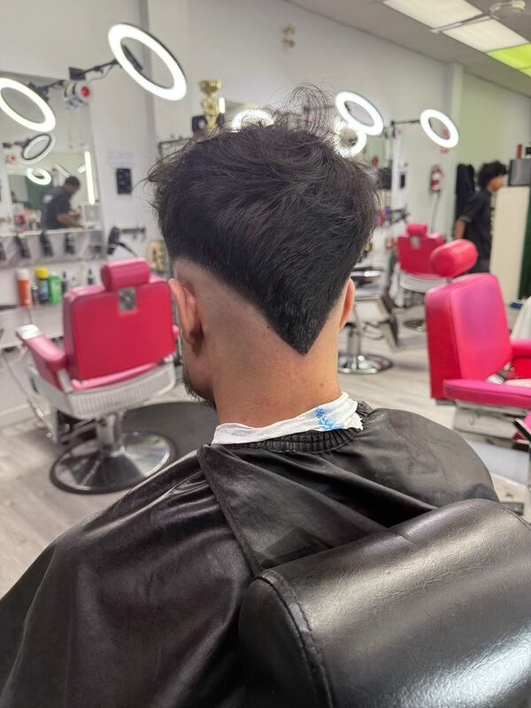 Back of the head showing a longer wavy top with a V-shaped tapered nape